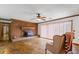 Bright living room featuring brick fireplace, wood trim and flagstone floors at 349 Asa Moseley Rd, Stockbridge, GA 30281