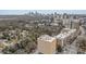 This aerial view captures the building and the neighborhood with city views and ample trees at 2285 Peachtree Ne Rd # 1107, Atlanta, GA 30309