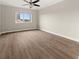 This bedroom features a ceiling fan, neutral walls, wood flooring and ample light at 2285 Peachtree Ne Rd # 1107, Atlanta, GA 30309