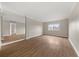 This bedroom features neutral walls, wood flooring, ample light and a mirrored wall to expand the space at 2285 Peachtree Ne Rd # 1107, Atlanta, GA 30309
