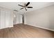 This bedroom features neutral walls, wood flooring, ample storage, ceiling fan and access to other rooms at 2285 Peachtree Ne Rd # 1107, Atlanta, GA 30309