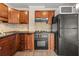 Traditional kitchen features wood cabinets, black appliances, neutral backsplash and laminate countertops at 2285 Peachtree Ne Rd # 1107, Atlanta, GA 30309