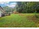 View of the large backyard, with deck, lush grass, and mature trees at 2549 Fontaine Cir, Decatur, GA 30032