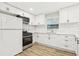 Well-lit kitchen with modern appliances, white subway tile backsplash, and white cabinets at 2549 Fontaine Cir, Decatur, GA 30032