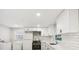 Well-lit kitchen with modern appliances, white subway tile backsplash, and white cabinets at 2549 Fontaine Cir, Decatur, GA 30032