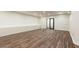 Spacious finished basement with wood-look flooring, recessed lights, and white wainscotting at 4421 Paradise Cir, Vinings, GA 30339