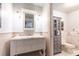 Charming bathroom with white vanity, marble countertop, beadboard paneling and linen storage at 4421 Paradise Cir, Vinings, GA 30339