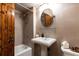 Classic bathroom featuring a pedestal sink, tiled walls, and a wood door at 4421 Paradise Cir, Vinings, GA 30339