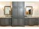 Bathroom featuring double vanities, unique mirrors, and ample storage at 4421 Paradise Cir, Vinings, GA 30339