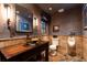 Unique bathroom with wood paneled walls, stylish sink, and stone tile flooring at 4421 Paradise Cir, Vinings, GA 30339