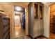View of the closet with wood floor and custom wardrobe with metal mesh door inserts at 4421 Paradise Cir, Vinings, GA 30339