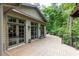 Large wooden deck features multiple access doors into the house and a beautiful view of the surrounding woods at 4421 Paradise Cir, Vinings, GA 30339