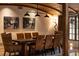 Stylish dining room with wood beams, a unique chandelier, and seating for ten at 4421 Paradise Cir, Vinings, GA 30339