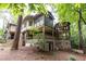 Back of house with patios overlooking wooded area at 4421 Paradise Cir, Vinings, GA 30339