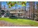 Beautiful two-story home with stone accents, private balconies, and well-manicured lawn surrounded by mature trees at 4421 Paradise Cir, Vinings, GA 30339