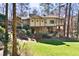A two-story traditional home with a manicured lawn surrounded by lush trees at 4421 Paradise Cir, Vinings, GA 30339