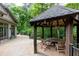 A gazebo on a wood deck next to house features a wood table and seating at 4421 Paradise Cir, Vinings, GA 30339