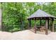 A gazebo on a wood deck features a wood table and seating at 4421 Paradise Cir, Vinings, GA 30339