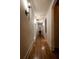 Well-lit hallway with hardwood floors and decorative wall sconces at 4421 Paradise Cir, Vinings, GA 30339