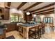 Spacious kitchen with wooden cabinets, large island with seating, and a farmhouse sink under a window at 4421 Paradise Cir, Vinings, GA 30339