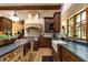 Beautiful kitchen with custom cabinets, a range hood, a farmhouse sink, and an island with a butcher block countertop at 4421 Paradise Cir, Vinings, GA 30339