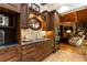 Charming kitchenette with dark wood cabinets, stone backsplash, and a round window at 4421 Paradise Cir, Vinings, GA 30339