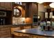 Elegant kitchenette featuring wooden cabinets, stone backsplash, and a unique round window at 4421 Paradise Cir, Vinings, GA 30339
