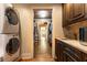 Adjacent laundry room with washer and dryer, cabinets, and sink at 4421 Paradise Cir, Vinings, GA 30339