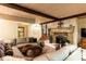 This living room has a stone fireplace, wood-beamed ceilings, and an eclectic mix of furniture at 4421 Paradise Cir, Vinings, GA 30339