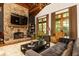 Cozy living room features stone fireplace, hardwood floors, comfortable seating, and large windows at 4421 Paradise Cir, Vinings, GA 30339