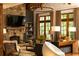 Inviting living room featuring a stone fireplace, wood beams, and large windows offering natural light at 4421 Paradise Cir, Vinings, GA 30339