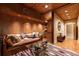 This living room has wood paneling, hardwood floors, and a comfortable leather couch at 4421 Paradise Cir, Vinings, GA 30339