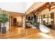 Open-concept living room with hardwood floors, stone fireplace, and expansive windows at 4421 Paradise Cir, Vinings, GA 30339