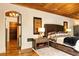 Spacious main bedroom has a wooden ceiling, unique decor, and hardwood floors at 4421 Paradise Cir, Vinings, GA 30339