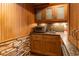 This convenient wet bar has wood cabinets, granite countertops, and stone accents at 4421 Paradise Cir, Vinings, GA 30339