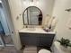 Bathroom showcasing a modern vanity, arched mirror, and stylish decor, creating a luxurious feel at 5674 Kingsport Dr # 4, Atlanta, GA 30342