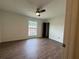 Bedroom with ceiling fan, wood-look floors and natural light from the window at 5674 Kingsport Dr # 4, Atlanta, GA 30342