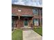 Inviting brick townhouse with a green door, a covered entry, and a well-manicured lawn at 5674 Kingsport Dr # 4, Atlanta, GA 30342