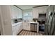 Charming kitchen with bright white cabinets, stainless appliances, and a lovely window view at 5674 Kingsport Dr # 4, Atlanta, GA 30342