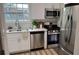 Updated kitchen featuring stainless steel appliances, bright white cabinets, and ample counter space at 5674 Kingsport Dr # 4, Atlanta, GA 30342