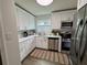Bright kitchen with white cabinets, stainless steel appliances, and a stylish striped rug at 5674 Kingsport Dr # 4, Atlanta, GA 30342