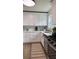 Well-lit kitchen with modern white cabinets, stainless appliances, and stylish flooring, perfect for cooking at 5674 Kingsport Dr # 4, Atlanta, GA 30342