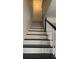Staircase with dark treads, white risers, and a traditional banister at 5674 Kingsport Dr # 4, Atlanta, GA 30342
