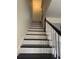 Bright staircase featuring black treads and white risers, leading to the upper level of this home at 5674 Kingsport Dr # 4, Atlanta, GA 30342