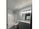 Bathroom features a gray vanity, granite counters, and a shower-tub combo at 3204 Fairington Village Dr, Lithonia, GA 30038