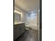 Modern bathroom featuring gray vanity, granite countertop, and shower-tub combination at 3204 Fairington Village Dr, Lithonia, GA 30038