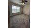 Apartment bedroom with neutral carpet, ceiling fan, and natural light through the window at 3204 Fairington Village Dr, Lithonia, GA 30038