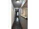 Apartment hallway leading to the kitchen, with updated lighting and flooring at 3204 Fairington Village Dr, Lithonia, GA 30038