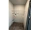 Apartment laundry room with hookups, wire shelf, neutral paint color, and luxury vinyl flooring at 3204 Fairington Village Dr, Lithonia, GA 30038