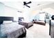 Spacious bedroom featuring three beds, light blue walls, and a ceiling fan at 5175 Bridle Point Pkwy, Snellville, GA 30039